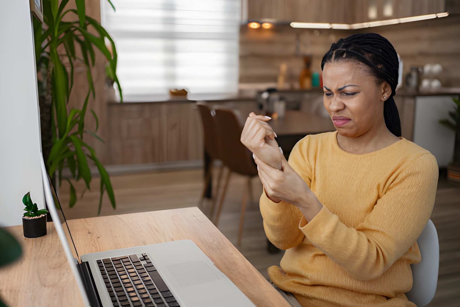 Woman feeling wrist pain from typing